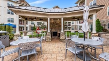 A patio with tables and chairs in front of a building
